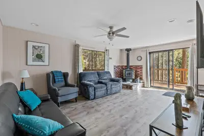 a living room with a couch and two chairs at Big Trees, Little Cabin in Arnold