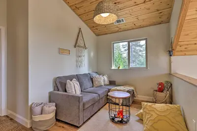 a living room with a couch and a window at Near Hiking and Wineries Arnold Cabin with Deck! in Arnold