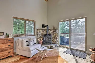 a living room with a couch and a fireplace at Near Hiking and Wineries Arnold Cabin with Deck! in Arnold