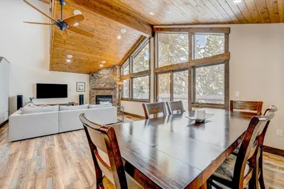 a dining room with a table and a couch at Windsor Lodge in Truckee