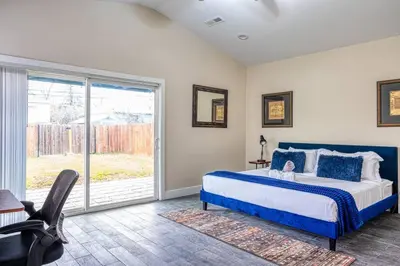 a bedroom with a bed and a sliding glass door at 4BR Victorian Walk to UC Davis & Shriner Med Cen in Sacramento