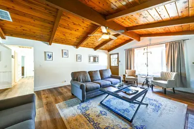 a living room with a couch and a table at Dog-Friendly Oakhurst Home Walk to Downtown! in Oakhurst
