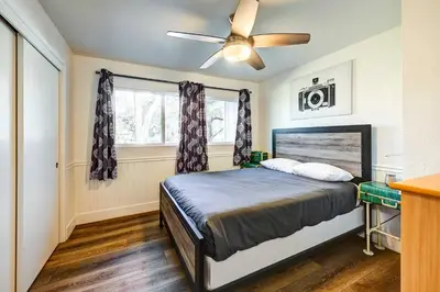 a bedroom with a bed and a ceiling fan at Dog-Friendly Oakhurst Home Walk to Downtown! in Oakhurst
