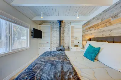 a bedroom with a large bed and a window at The Home at the End of the Rainbow in South Lake Tahoe