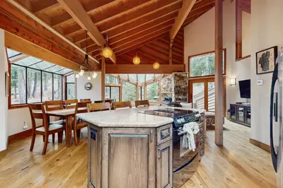 an open kitchen and dining room with a dining table at North Star Mountain Retreat in Truckee
