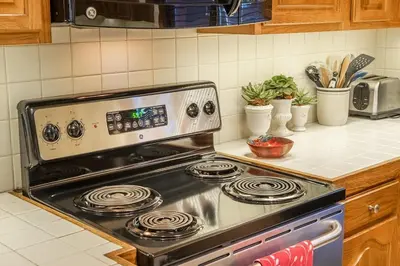 a stove top oven sitting in a kitchen at Townhouse Art Gallery in Mammoth's Best Location in Mammoth Lakes