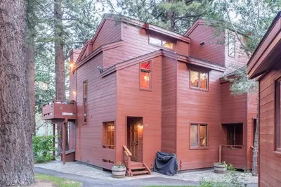 a red house with a tree at Townhouse Art Gallery in Mammoth's Best Location in Mammoth Lakes