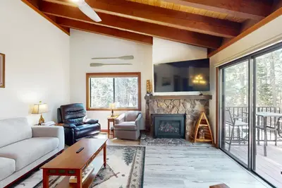 a living room with a couch and a fireplace at Tree-Lined Views #8 in Tahoe City