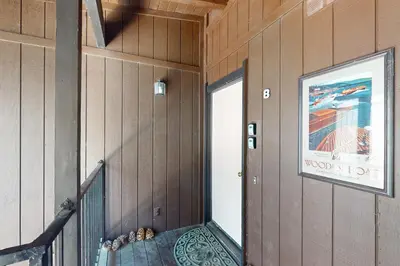 a hallway with a door in a room with wooden walls at Tree-Lined Views #8 in Tahoe City
