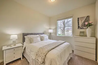 a bedroom with a large bed and a window at Visalia Home with Yard 4 Mi to Downtown! in Visalia