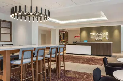 a lobby with a bar with chairs and a welcome sign at Hampton Inn Stockton, Ca in Stockton