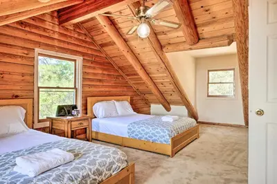 a bedroom with two beds and a ceiling fan at Stunning Log Cabin with Great Views, Firepit, Deck near Twain Hart in Sonora
