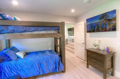 a bedroom with a bunk bed and a wooden dresser at Creek Side Summit home in Stateline