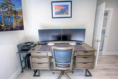 a desk with a computer and a chair in a room at Creek Side Summit home in Stateline