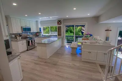 a large kitchen with white cabinets and a large island at Creek Side Summit home in Stateline