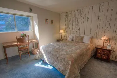 a bedroom with a bed and a desk and a window at Life's Better The Milky Way condo in Stateline