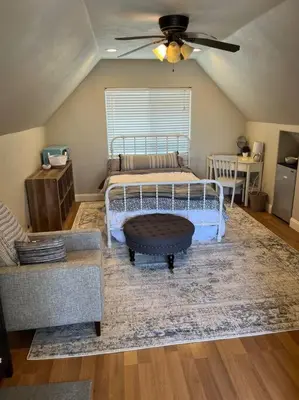 a bedroom with a bed and a couch and a table at Adorable 1 Bedroom with pool, and Horse Arena in Oakdale