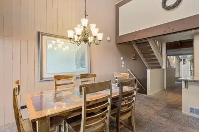 a dining room with a table and chairs and a chandelier at Our Happy Place home in South Lake Tahoe