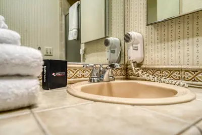 a bathroom sink with a hair dryer and a phone at Three-Bedroom House in South Lake Tahoe