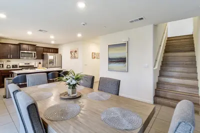 a dining room and kitchen with a table and chairs at Pool Table and Patio! Spacious Merced Getaway in Merced