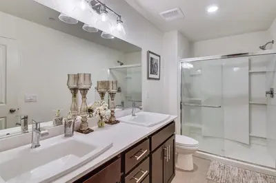 a bathroom with a sink and a shower and a toilet at Pool Table and Patio! Spacious Merced Getaway in Merced
