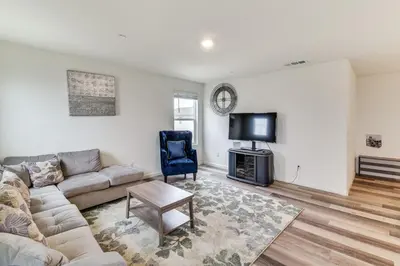 a living room with a couch and a tv at Pool Table and Patio! Spacious Merced Getaway in Merced