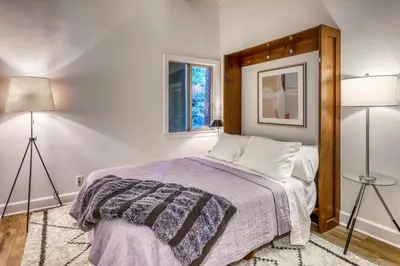 a bedroom with a bed and two lamps and a window at Inviting Tahoe Escape in Incline Village