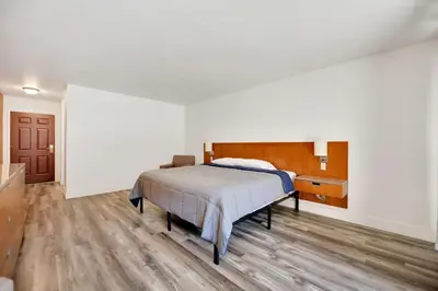 a bedroom with a bed and a wooden floor at Amador Hotel in Pioneer