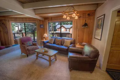a living room with a couch and chairs and a table at Rocky Top Retreat home in South Lake Tahoe