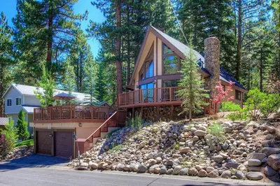 a large house with a deck on a pile of rocks at Rocky Top Retreat home in South Lake Tahoe