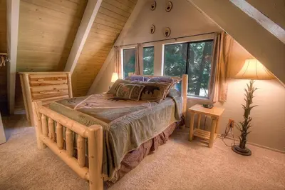 a bedroom with a wooden bed in a attic at Rocky Top Retreat home in South Lake Tahoe