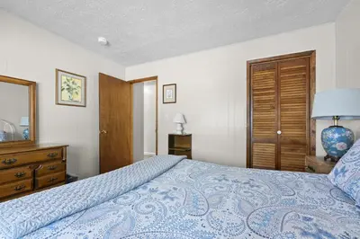 a bedroom with a bed and a dresser and a mirror at Cozy Cabin home in South Lake Tahoe