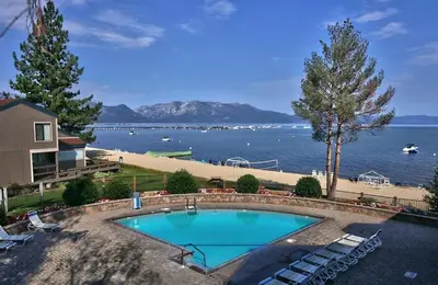 a swimming pool with a view of the water at Sky Lake Splendor condo in South Lake Tahoe