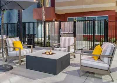 a group of chairs and a fire pit in a patio at Fairfield by Marriott Inn & Suites Stockton Lathrop in Lathrop