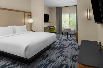 a hotel room with a bed and a desk at Fairfield by Marriott Inn & Suites Stockton Lathrop in Lathrop
