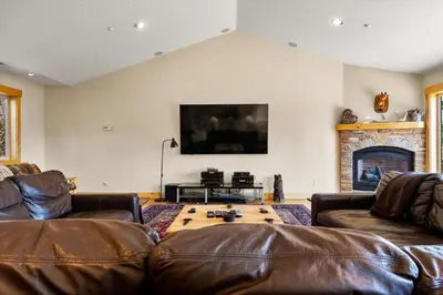 a living room with two leather couches and a tv at Shaquinaw! home in South Lake Tahoe