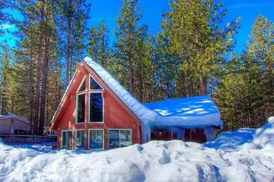 a red barn with snow on the roof at Snowshoe Chalet cabin in South Lake Tahoe