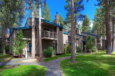 an exterior view of a large house with trees at Bear Lake Hideaway condo in South Lake Tahoe