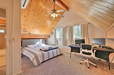 a bedroom with a bed and a desk with a computer at Pine Mountain Lake Cabin with Grill! in Groveland