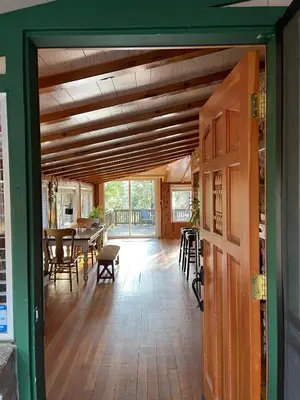 an open door into a dining room with a table at Twain Harte Cabin in Town & Lake access in Twain Harte