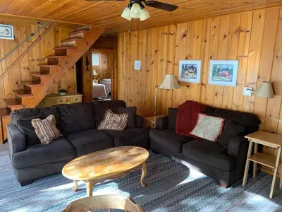 a living room with a couch and a table at Cabin #3 in Strawberry
