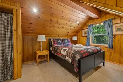 a bedroom with a bed in a log cabin at Cabin #4 in Strawberry