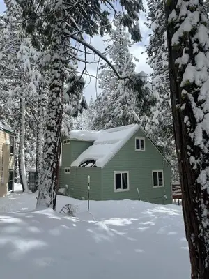 a green house with snow on top of it at Cabin #4 in Strawberry
