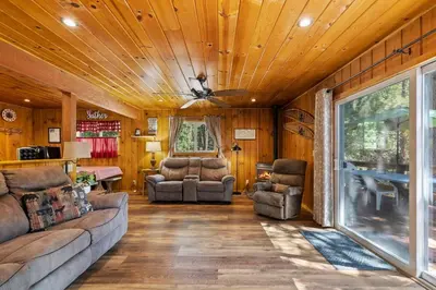 a living room with a couch and chairs and a table at Cabin #4 in Strawberry