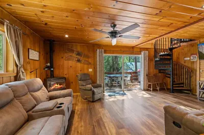 a living room with a couch and a ceiling fan at Cabin #4 in Strawberry