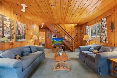 a living room with blue couches and a staircase at Cabin #5 in Strawberry