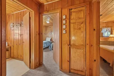 a hallway of a home with wooden walls and wooden doors at Cabin #2 in Strawberry