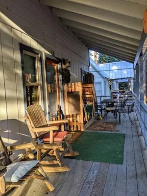 a porch with two rocking chairs on a house at Cabin #7 in Strawberry