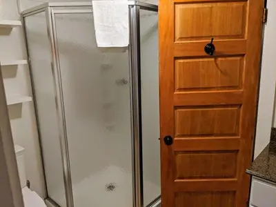 a shower with a glass door in a bathroom at Cabin #7 in Strawberry