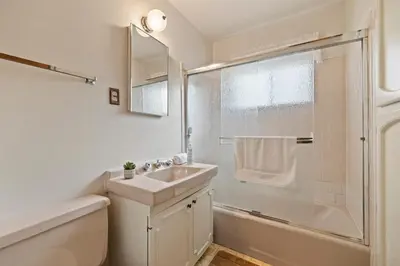 a white bathroom with a sink and a shower at Cabin #10 in Strawberry